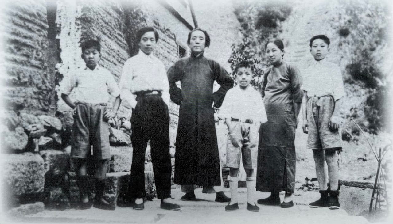 涵靜老人與家人在華山合影留念，數位成人與孩子站立於山間石階或空地上，背景可見華山山壁與植被，眾人神情從容，著民國時期服飾。
